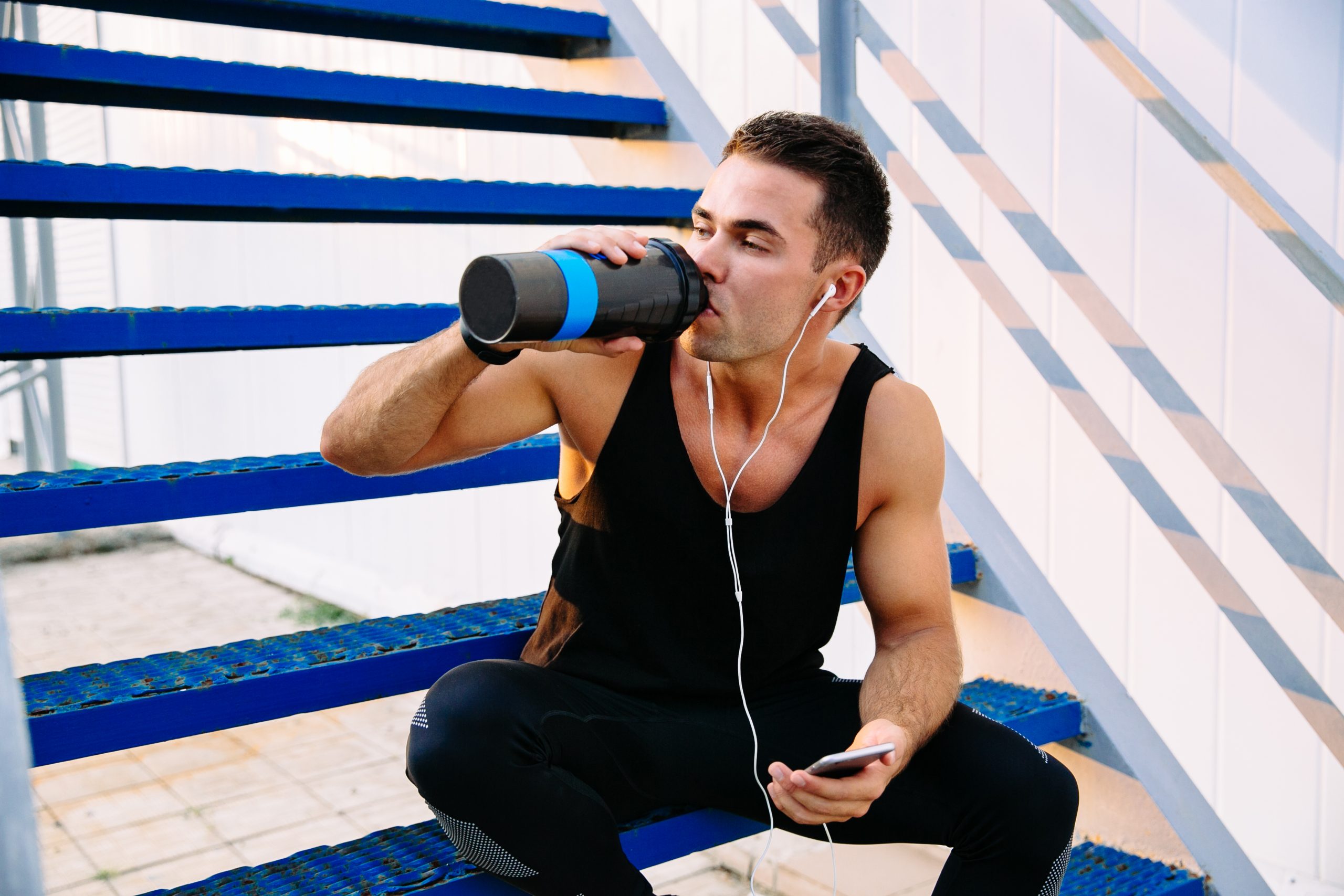 Sportsman drinking a water after workout, outdoors